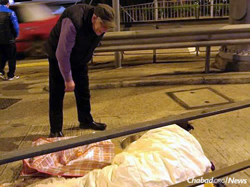 Making sure those hunkered down on Hong Kong's streets had a blanket for warmth. Photo courtesy Chabad.org/News.