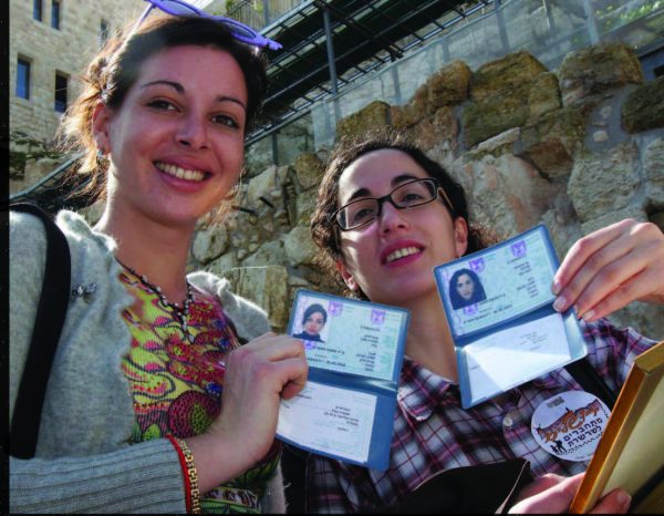 Two French olim proudly showing their new Israeli ID cards. Photo courtesy The Jewish Agency.