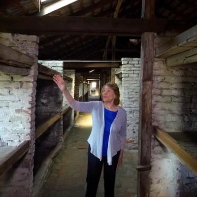 Fritzie Fritzshall, a Holocaust survivor, guides viewers through a virtual reality tour of the Auschwitz barracks.