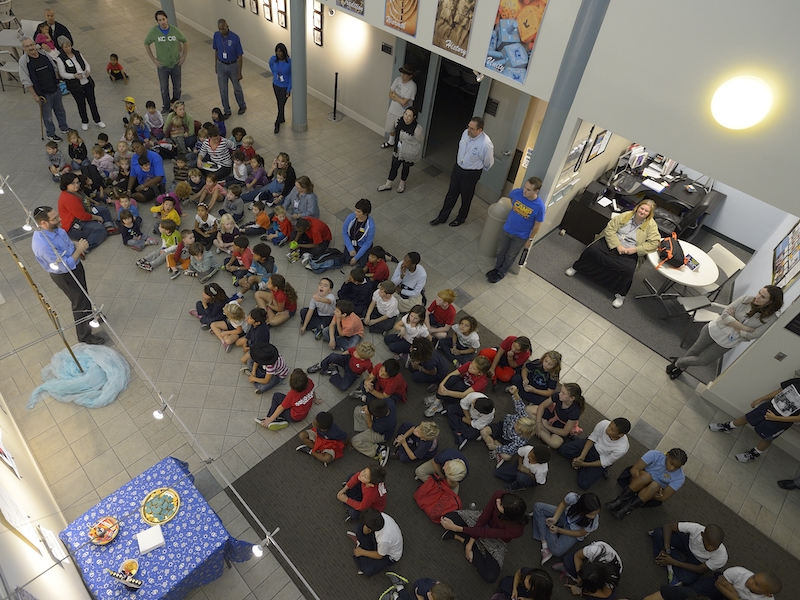 Rabbi David Cantor lights a candle on the first night of Hanukkah with children at the Alpert Jewish Community Center in Long Beach, Calif., in 2013. Long Beach is one of many Jewish communities whose population is being evaluated in a new study.