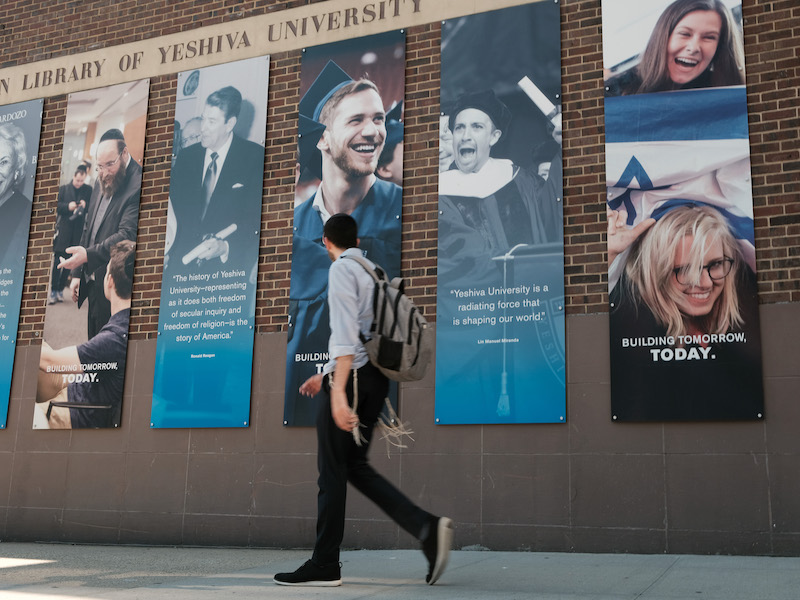 A man walks by the exterior of a Yeshiva University building in 2022.