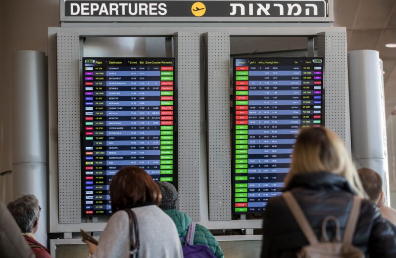 Passengers check an information board at Ben Gurion Airport near Tel Aviv on Dec. 17, 2017.