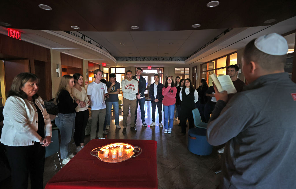 Ethan Sobel, left, managing director of Boston University Hillel, reads kaddish at a memorial ceremony in October 2023. 