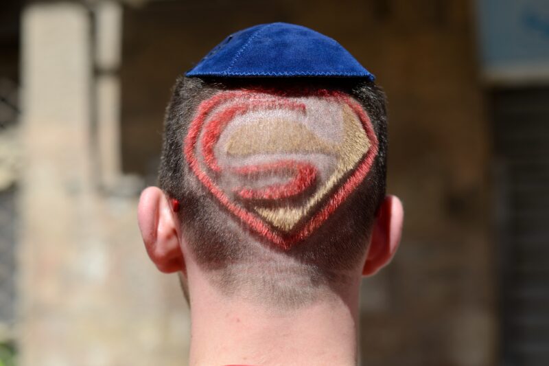 Illustrative. A Jewish man wearing a blue kipa and and having a haircut with Superman sign is seen from the back during the Purim holiday in Jerusalem's Mea Shearim neighborhood on March 6, 2015.