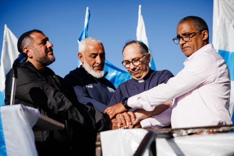 Illustrative. Rabbi Haim Bendao, Rachid Zeroual, leader of the Olympique de Marseille South Winners fan club, priest Olivier Spinosa and Imam Hassan Rajii hold hands outside Notre-Dame de la Garde Basilica during an interfaith peace rally held by Jewish, Muslim, and Christian religious leaders, in Marseille, France, on Oct. 24, 2023.