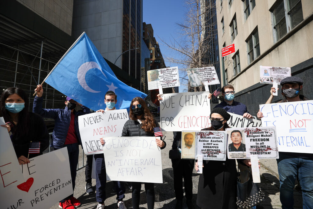 People hold banners during a protest against the Chinese goverment's treatment of its Muslim Uyghur population in New York City on March 22, 2021.